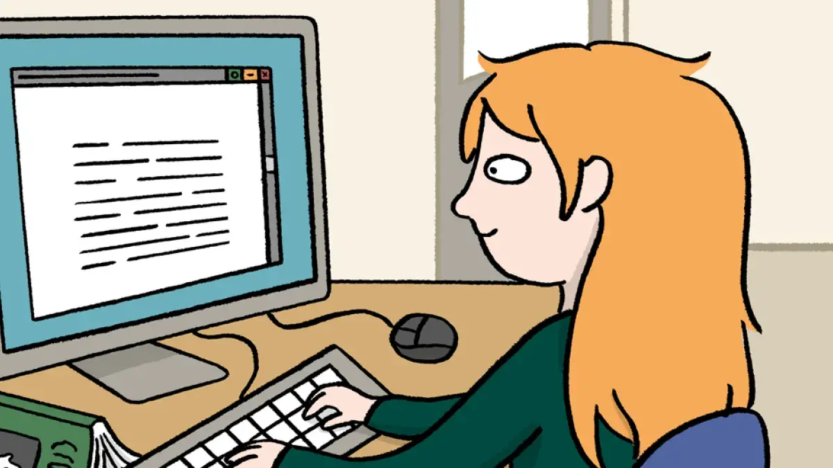 a girl sitting in front of a computer
