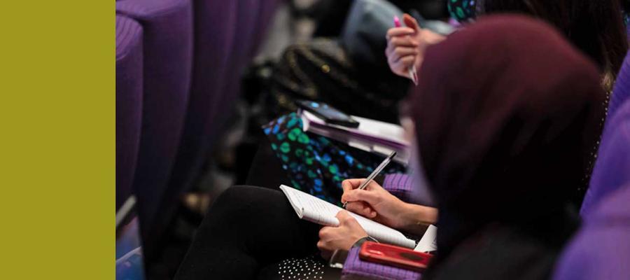 Photo of delegates writing notes