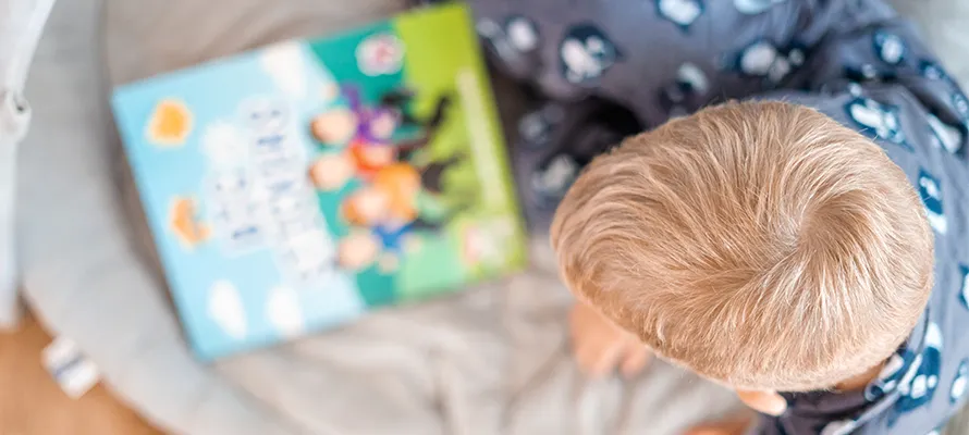 Birdseye view of a child reading a book