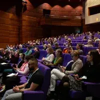 Widescreen photo of audience seated in lecture theatre