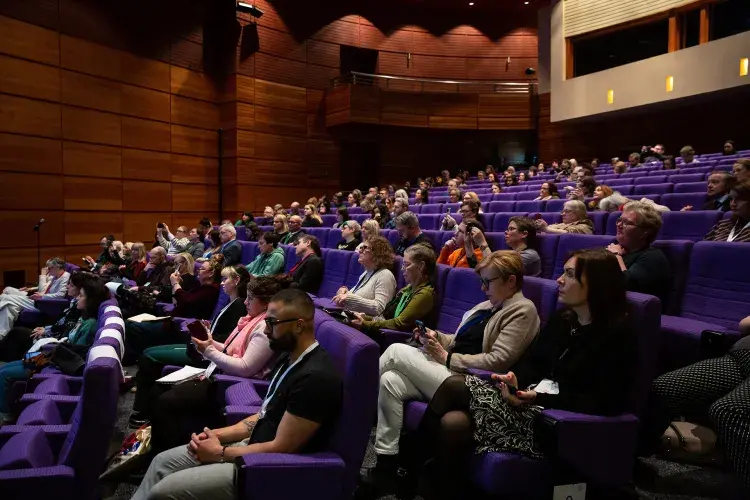 Widescreen photo of audience seated in lecture theatre
