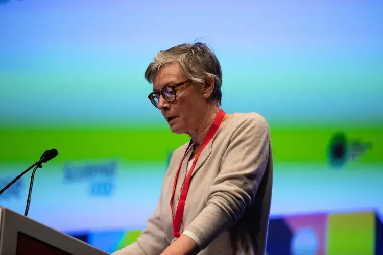 Photo of female speaker at lecturn